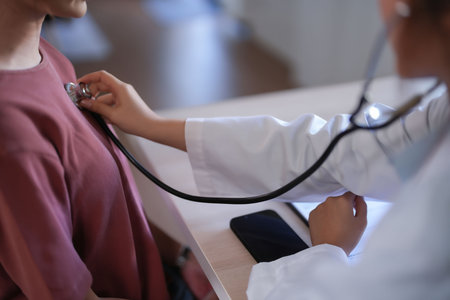 Asian psychologist women using stethoscope to check up patient and giving counseling about medicine and mental health therapy while female patient stress and anxiety with psychological health problem.の写真素材