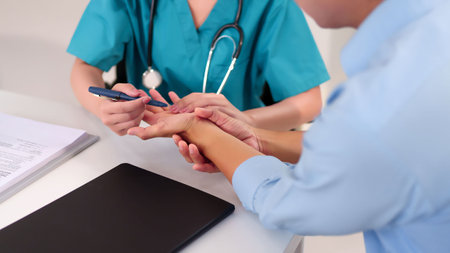 Adult Asian woman doctor examining adult patient's hand with pen in clinic. Healthcare professional provides consultation treatment for the patient about health conditionの写真素材
