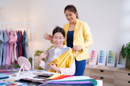 An Asian adult woman gets personal color analysis consultation from a stylist. Discover perfect shades that complement your skin tone, hair and eyes for a radiant style.の写真素材