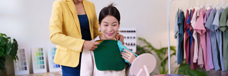 An Asian woman receives personal color analysis from a stylist, who is helping her choose the right colors to complement her complexion and style her wardrobe.の写真素材