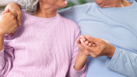A touching image featuring an older couple holding hands showcasing affection care and lifelong partnership Explore the beauty of senior love and devotionの写真素材