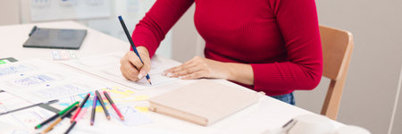 Adult Asian women in UI UX role designing website or application layout and user interface on paper for startup project. Focus on hands creating prototypesの写真素材