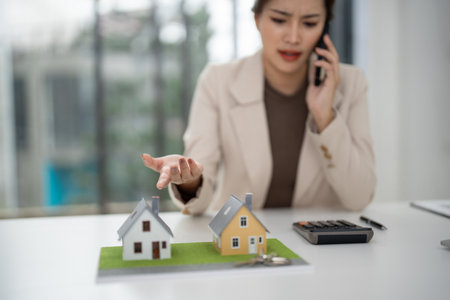 Professional real estate agent consults client property investment residential development. Busy modern office.の写真素材