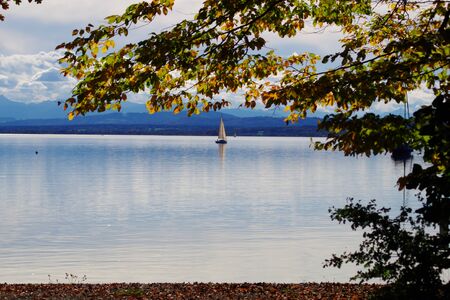 Ammersee with Sailboat in autumn Bavariaの写真素材