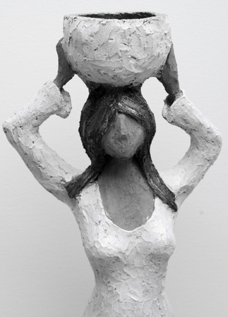 Sculpture of a upright and confident woman carries water on her headの写真素材