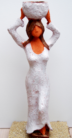 Sculpture of a upright and confident woman carries water on her headの写真素材