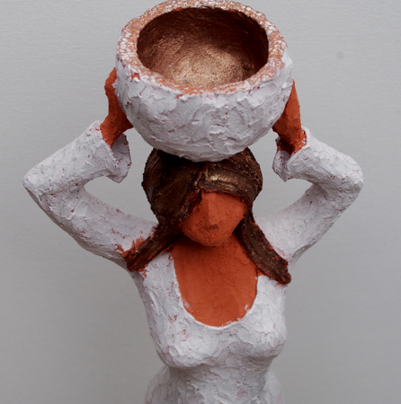 Sculpture of a upright and confident woman carries water on her headの写真素材