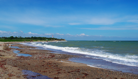 Steep coast with lighthouse on the Baltic sea near Heiligenhafenの写真素材