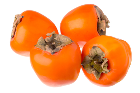 Four persimmons closeup isolated on white background.の写真素材