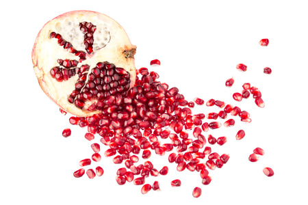 One half pomegranates with seeds isolated on white backgroundの写真素材