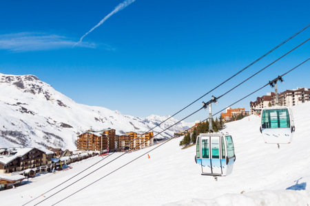 Gondola on the background of the village of Les Menuires. Resort 3 Valleys, French Alps