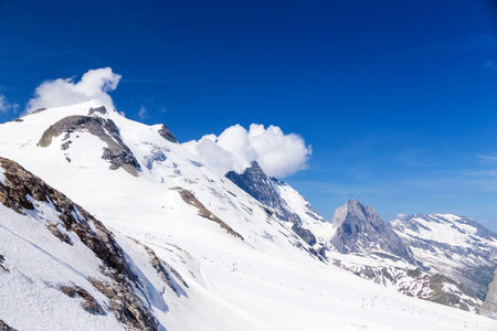Mountain and glacier Grand Motte in the clouds. Ski tow and summer skiing area of Tignes.