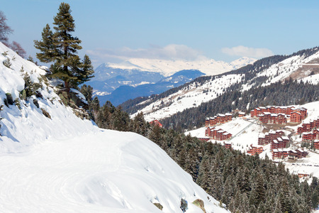 Mountain skitracks on the background of the village of Meribel Mottaret, France.の写真素材