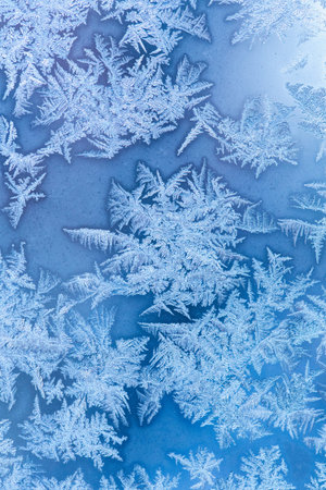 Frosty winter pattern at a window glass, macro texture