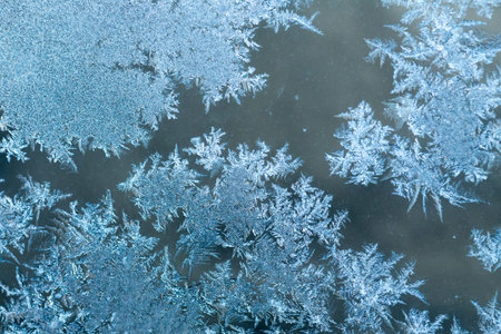 Frosty winter pattern at a window glass, macro texture