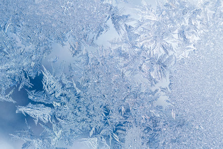 Frosty winter pattern at a window glass, macro texture