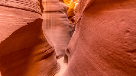 Narrow walkway inside The Lower Antelope Canyon, Light shines down through the crevices of the sandstone, Arizona, USAの写真素材