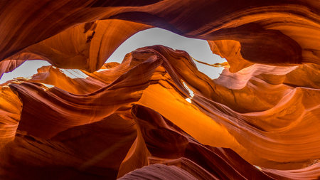 Fissures in the sandstone at the Lower Antelope Canyon, when light shines on them, create colorful patterns of light and shadow on the sandstoneの写真素材