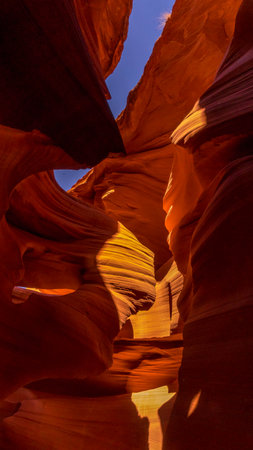 Fissures in the sandstone in the exit area You can see the sky and the light creates colorful patterns on the sandstone at The Lower Antelope Canyon in Arizona,の写真素材