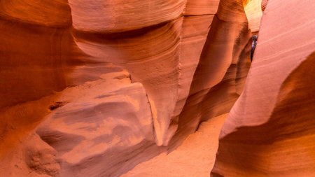 Narrow walkway inside The Lower Antelope Canyon, Light shines down through the crevices of the sandstone, Arizona, USAの写真素材