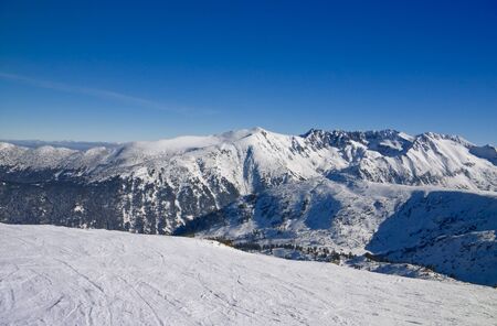 Sli slope and panorama of winter mountains. Alpine ski resort Bansko, Bulgariaの写真素材