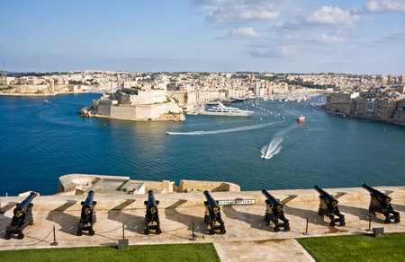 View to Vittoriosa Harbor and medieval cannons battery from Valetta wall, Maltaの写真素材