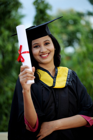 Young female student with diploma at outdoorsの写真素材
