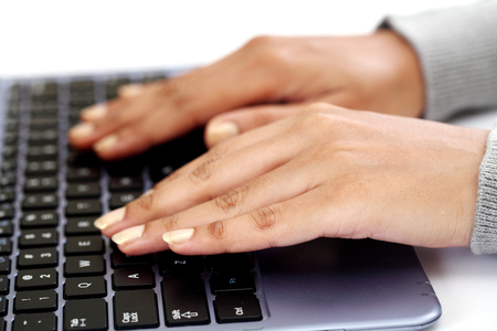 Woman hands busy using laptop at office deskの写真素材