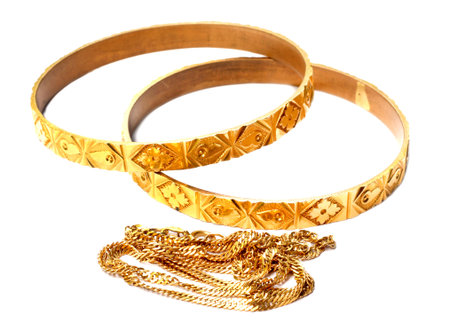 Wedding gold bracelets on white backgroundの写真素材