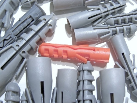 heap of grey dowels and red one       の写真素材