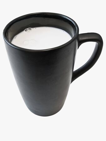 Isolated black cup with white milk against the white background の写真素材