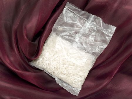 White rice pack at the burgundy textileの写真素材