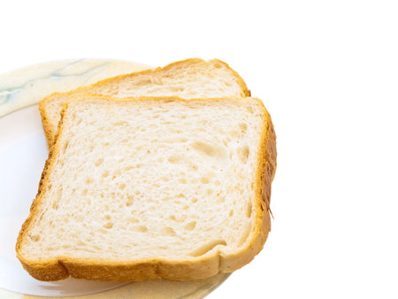 Two pieces of white bread at the plate 