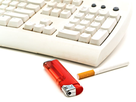 keyboard, cigarette and  lighter at the white tableの写真素材