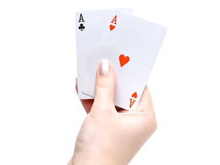playing cards in the woman hand against the white backgroundの写真素材