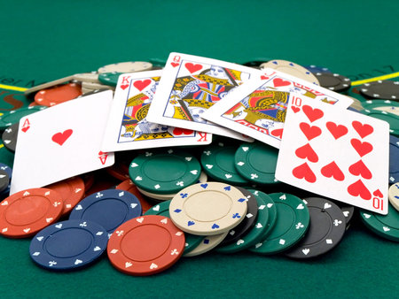 playing cards at the chips at the green table into the casino