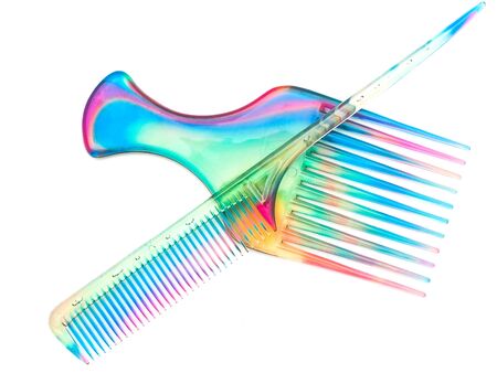 two multicolored combs at the white backgroundの写真素材
