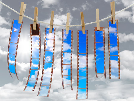 colored films at the pegs against the cloudy sky 
