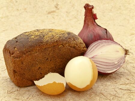 black bread with red onion and egg  over beige background  の写真素材