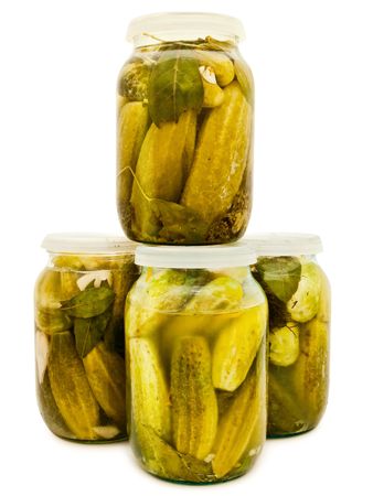 glass jars with marinated cucumbers against the white backgroundの写真素材