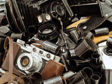 retro photo accessory with many films and vintage camerasの写真素材