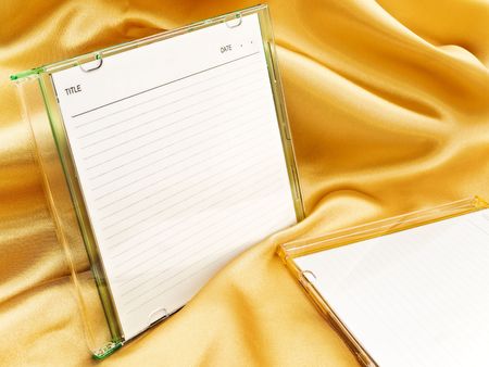 cd disc with blank cover over the gold backgroundの写真素材