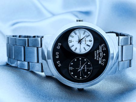 Photo of blue style photo of fashioned man watch at the fabric の写真素材