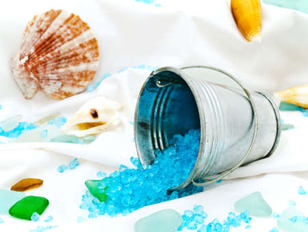 marine decor with sea shells, bucket and decorative stones at whiteの写真素材