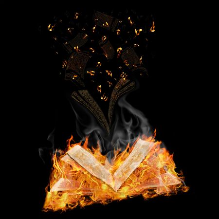 open magic book in flame and flying letters against black background の写真素材
