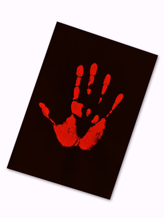 red hand print on the black paperの写真素材