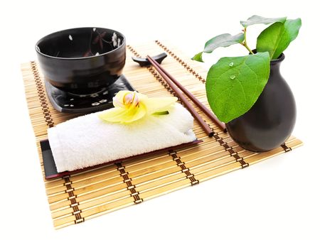 oriental style table serving with orchid and green leavesの写真素材