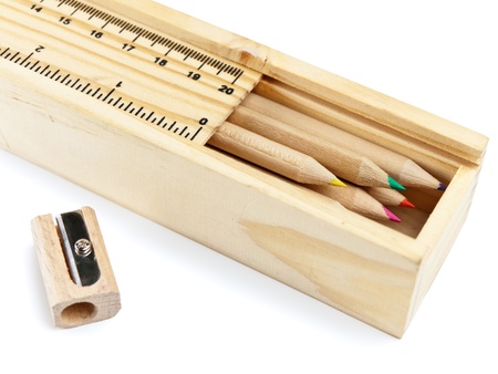 wooden pencil case with colour pencils on white backgroundの写真素材