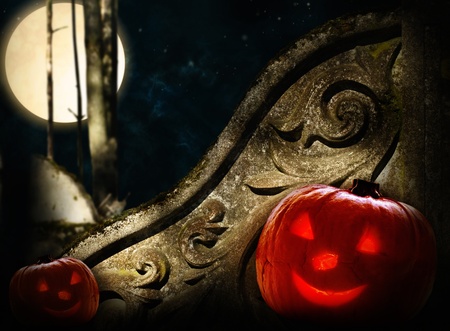 ancient decorated wall in night forest with big moon and two Halloween pumpkinsの写真素材