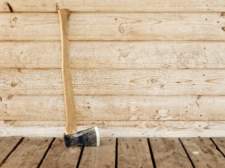 single old hatchet near the wooden wall